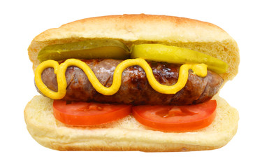 Grilled bratwurst, pickle, tomato and mustard on a bun isolated on white