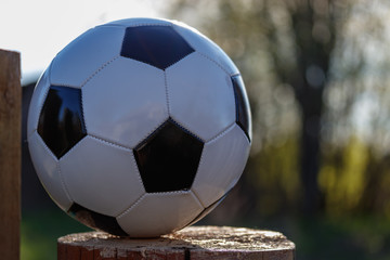 Classic soccer ball in the backlight, sunlight on a beautiful bokeh background