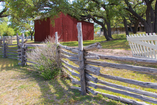 wooden fence and a red barn