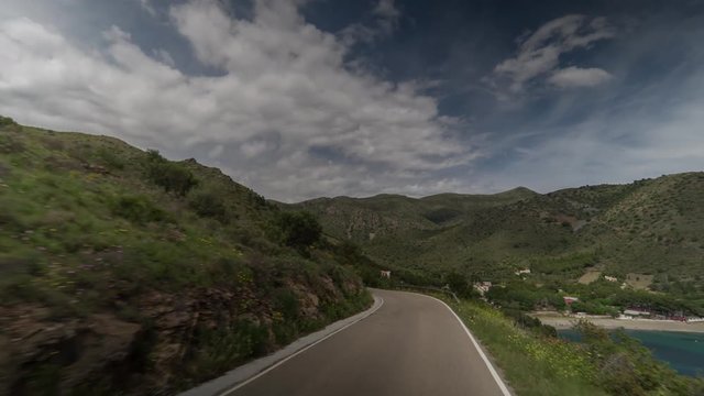 POV shot of the cami de ronda de Roses coastline in catalunya, spain shot from the front of an off road vehicle