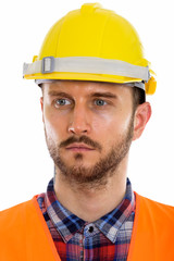 Young handsome bearded man construction worker