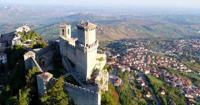 Old castle, C4k aerial rising tilt view of Guaita fortress, on a sunny autumn day, in San Marino city