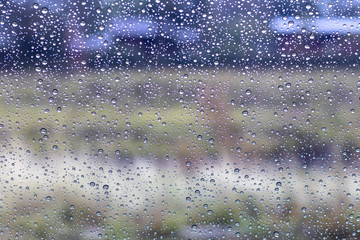 Rain drops on windshield with rural.