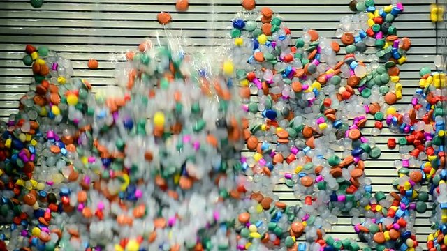 abstract random color components heap under water on metal silver grid, industrial items closeup
