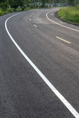 Curved road surface, which is new paved.