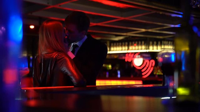 Unfaithful husband meeting secretly lover woman in nightclub, lie, betrayal