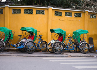 Traditional vehicle of Vietnam parked near the yellow wall in Hoi An Vietnam