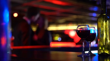 Drunk woman kissing man in bar, doing first step in relations, affectionate