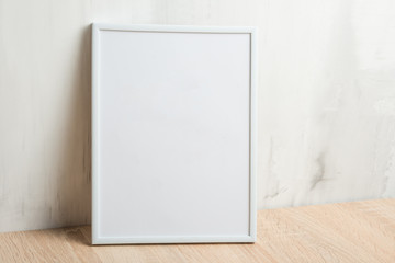 Empty white frame on the wall background. The concept of design and font inscriptions and image placement