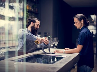 Bartender pouring a wine to the glass