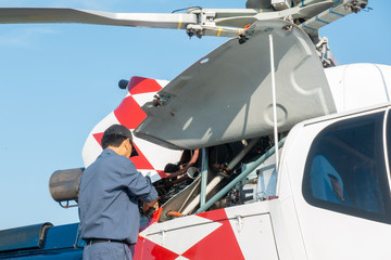 Engineer maintaining a helicopter Engine