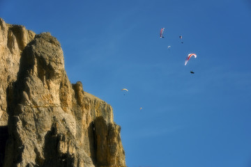 Fototapeta na wymiar People on hang gliders in action, Sella, Dolomites, Italy 