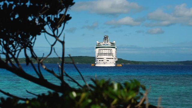 Scenic view of beautiful blue ocean with cruise ship at Lifou tropical island, New Caledonia.