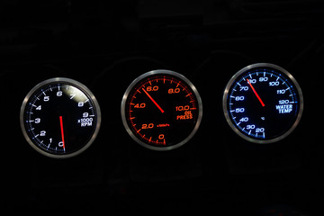 Modern car instrument dashboard panel in night time