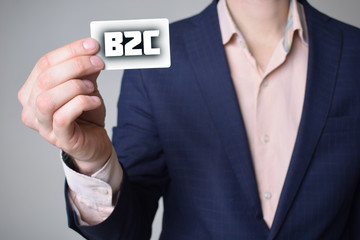 Businessman shows business card with the inscription:B2C