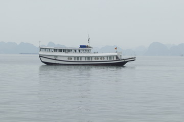 Fototapeta na wymiar Tourist ferry boat in Halong Bay, the Unesco world heritage site in Vietnem.