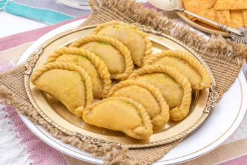 Gujiya or Gujia is a indian sweet dumpling made with suji, Maida or wheat flour and stuffed with khoya. It is common in North India, particularly in Bihar, Uttar Pradesh, Madhya Pradesh or Rajasthan