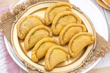 Gujiya or Gujia is a indian sweet dumpling made with suji, Maida or wheat flour and stuffed with khoya. It is common in North India, particularly in Bihar, Uttar Pradesh, Madhya Pradesh or Rajasthan