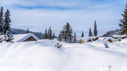 Deep snow pack covering houses and roads of the alpine village of Sun Peaks in the Shuswap Highlands of central British Columbia, Canada