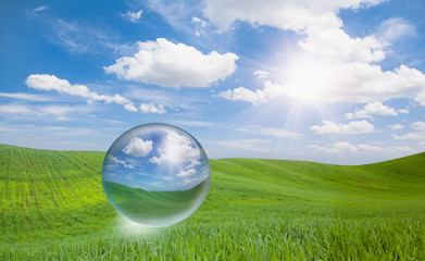 Green grass field and bright blue sky - crystall ball