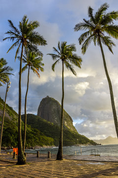 Sunsire at Praia Vermelha (Vermelha beach) with Pao de Acucar (Sugar Loaf Mountain) on the background. Rio de Janeiro, Urca, Brazil