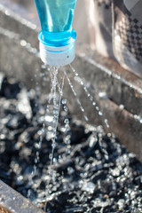 Extinguishing water from a bottle of coal in the grill