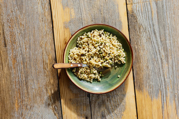 Pearl barley couscous green peas wooden table top view Healthy food concept