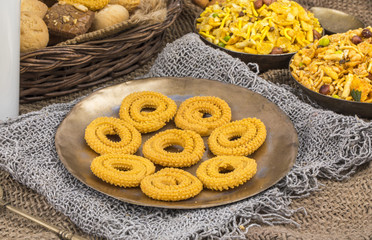 Indian Traditional Deep Fried Snack Chakli with Namkeen Also Called Chakali, Chakri, Murukku, Muruku, Murkoo on Vintage Background