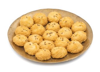 Salted Flavor Small Cumin Cookies or Biscuits Served in Plate Also Know as Nan Khatai or Jeera Cookies is a tea time Snack. Little Sweet and Little Salty isolated on White Background