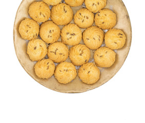 Salted Flavor Small Cumin Cookies or Biscuits Served in Plate Also Know as Nan Khatai or Jeera Cookies is a tea time Snack. Little Sweet and Little Salty isolated on White Background