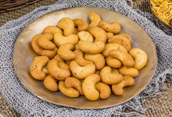 Salted Flavor Roasted Cashew Nut Snacks Served in Plate Also Know as in India Kaju Namkeen or Masala Kaju on Vintage Background