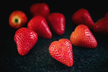 Ripe strawberries on a black background