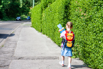 Little girl on her way to her first day of school