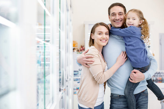 Vitamins For Family. Energetic Exuberant Family Embracing And Looking At Camera