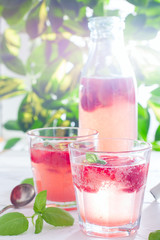 Summer refreshing drink made of strawberries and basil in glassware, summer background, selective focus
