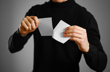 Man tearing a piece of paper in half blank white flyer brochure booklet. Leaflet presentation....