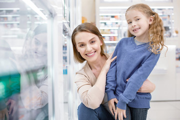 I love you. Jolly positive woman hugging girl and smiling to camera