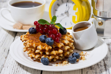 waffles with berries and caramel for breakfast, closeup