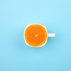 Top view coffee cup with citrus on blue background, concept summer minimal morning