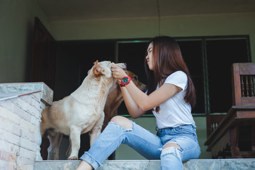 Young women playing with a dog ,life style .