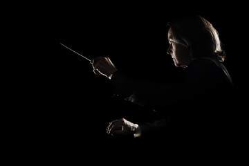 Orchestra conductor music conducting with baton