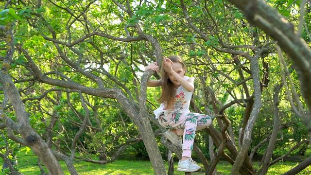 Cute girl in blooming apple tree garden enjoy the warm day