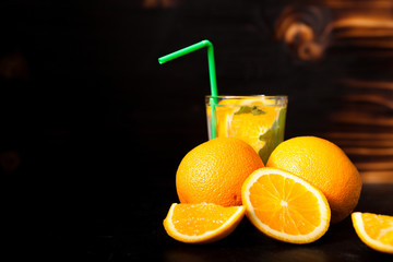 Fresh organic orangeade made of natural fruits on vintage wooden background