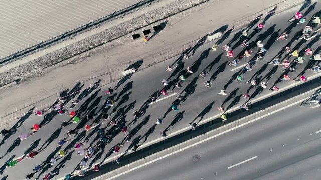 4K Aerial drone fooage. Marathon running on street. Camera rotate. Top view