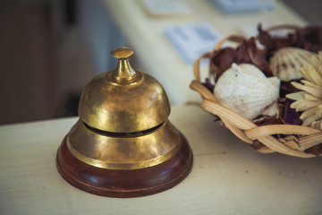 Vintage service bell on reception desk in hotel, close-up