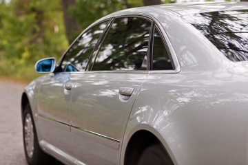 Fototapeta na wymiar Rear wing of large luxury silver car