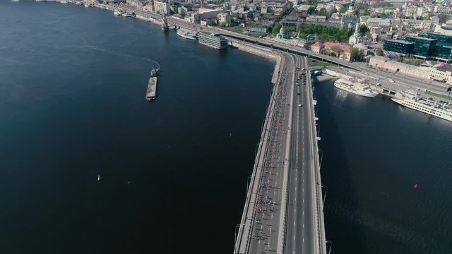 4K Aerial drone fooage. Marathon running on the bridge. Wide shot.