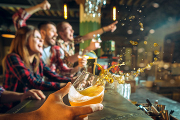 sport, people, leisure, friendship and entertainment concept - happy football fans or male friends drinking beer and celebrating victory at bar or pub - obrazy, fototapety, plakaty