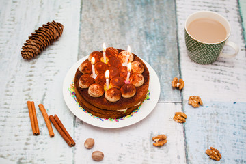 Tiramisu cake with candles and coffee