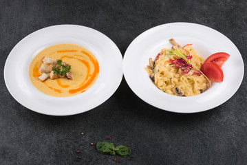 Complex dinner. Italian paste of carbonaria with mushrooms with cream sauce on a white plate